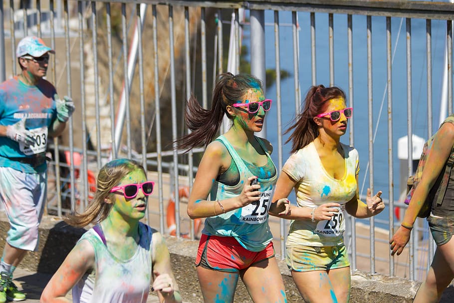 three, women, running, gray, metal fence, woman, body, paint, daytime, color run