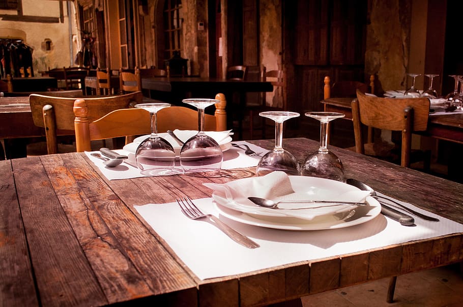 rectangular, brown, wooden, farm table, plates, wine glasses, restaurant, table, dining, glasses