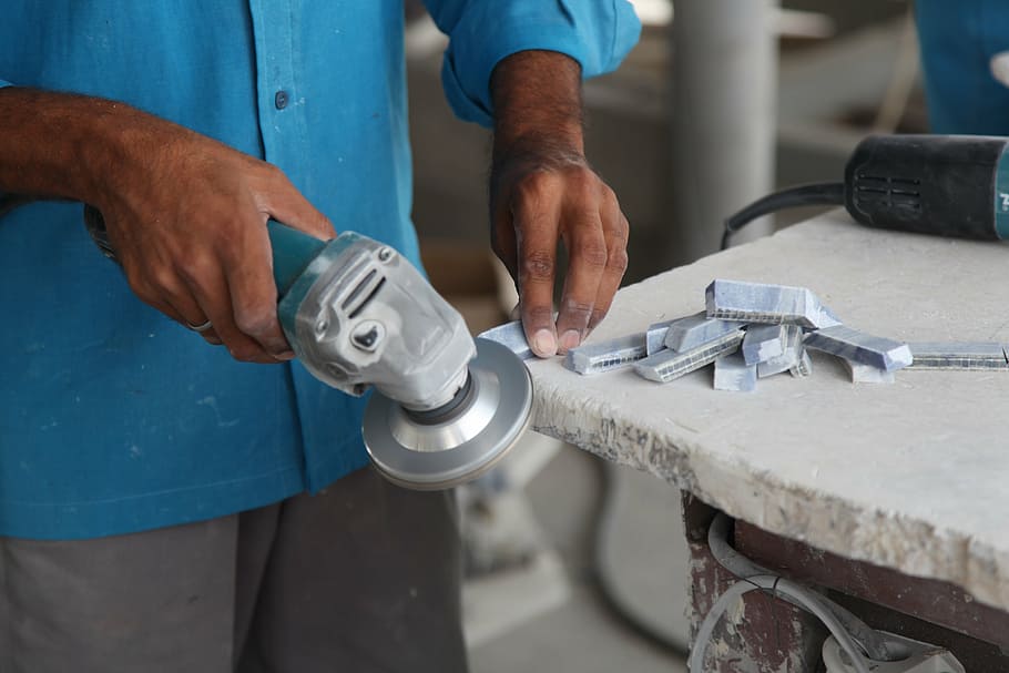 man, holding, turned-on angle grinder, marble, granite, grinding, work, hands, polish, occupation