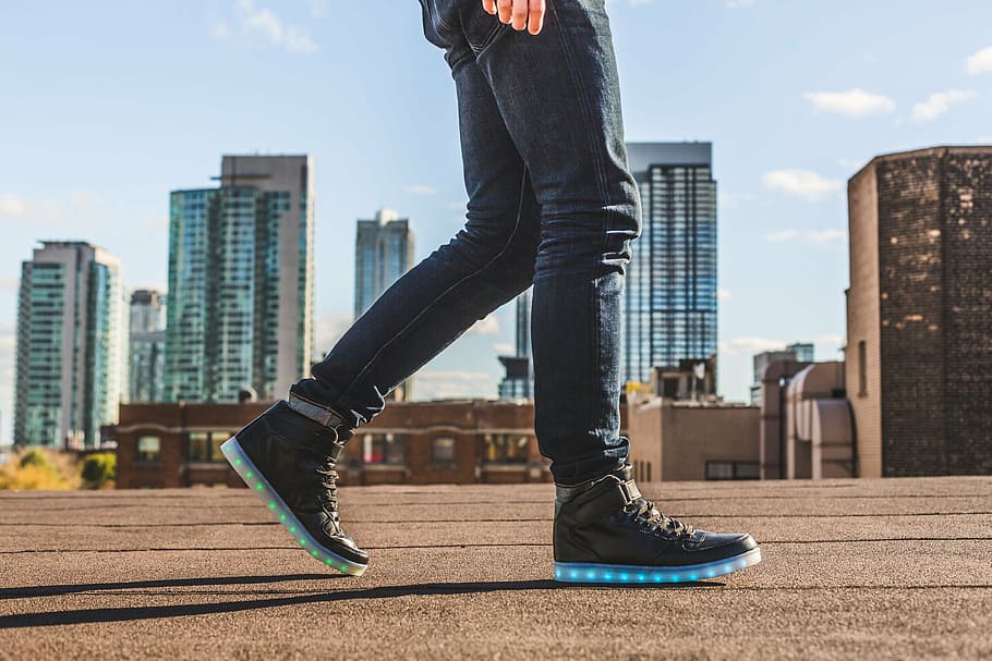 person, wearing, black-and-blue, led, high-top sneakers, architecture, building, infrastructure, blue, sky