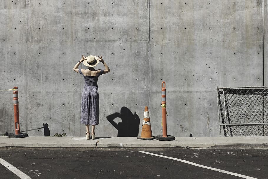 building, concrete, pavement, person, retro, shadow, street, wall, woman, day