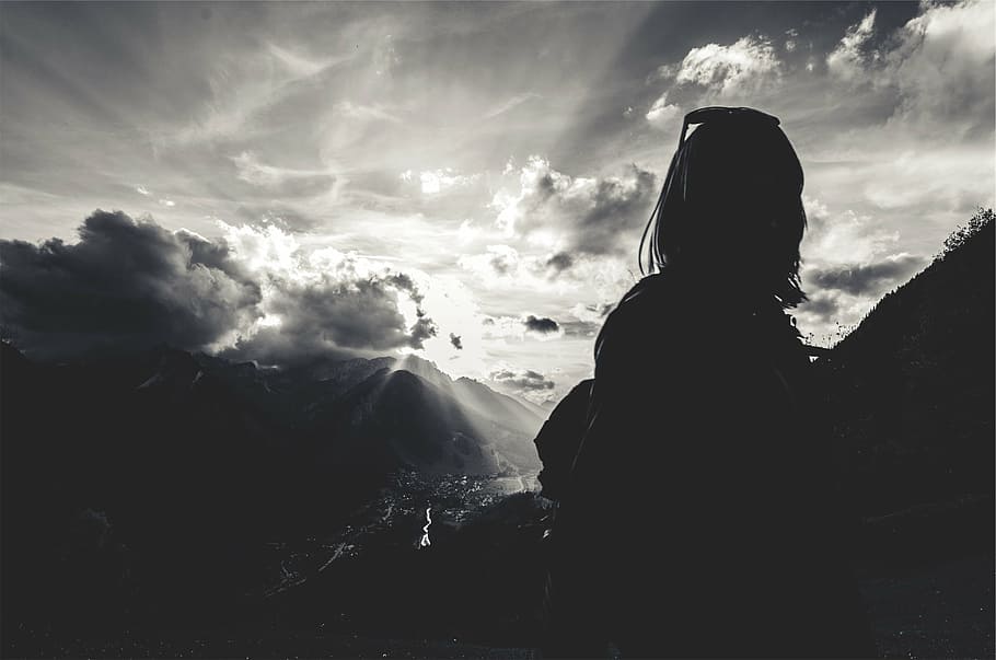 silhouette photograph, woman, clouds, background, silhouette, person, across, mountain, sunbeams, girl