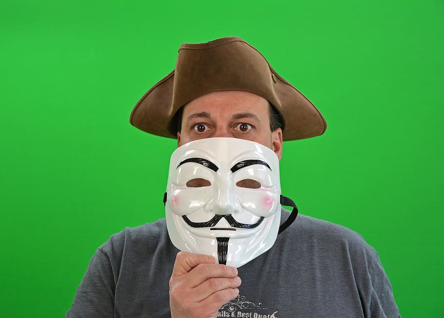 man, wearing, brown, hiking, hat, holding, guy fawkes mask, chroma key, greenbox, anonymous