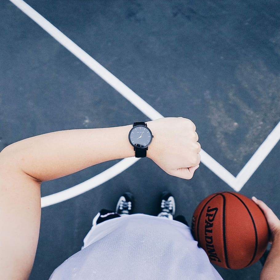 person, wearing, black, analog, watch, holding, spalding basketball, analog watch, spalding, basketball