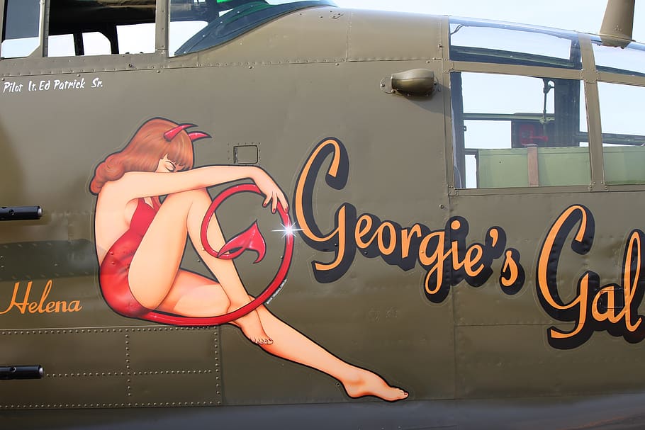 nose art, b-25, ww2 aircraft, text, communication, real people, western script, one person, lifestyles, window