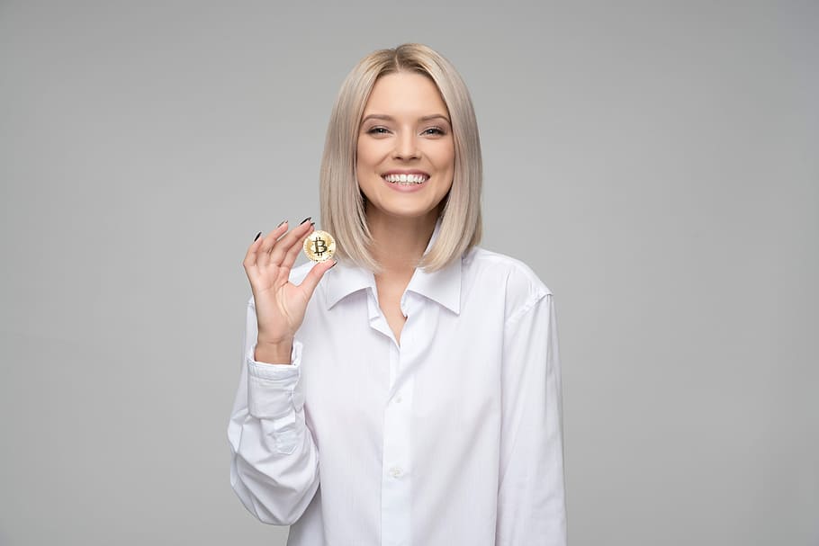 smiling, woman, holding, bit coin, cryptocurrency, bitcoin, finance, blockchain, money, mining