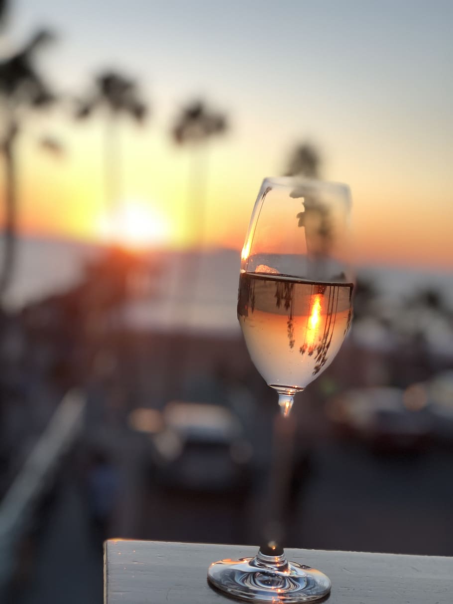 at dusk, palm trees, sea, beach, champagne, wine glass, sunset, glass, sky, focus on foreground