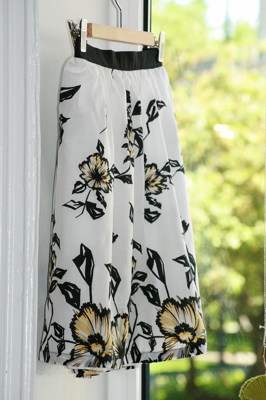 shallow, focus photo, white, black, yellow, floral, skirt, hanging, gucci, store window