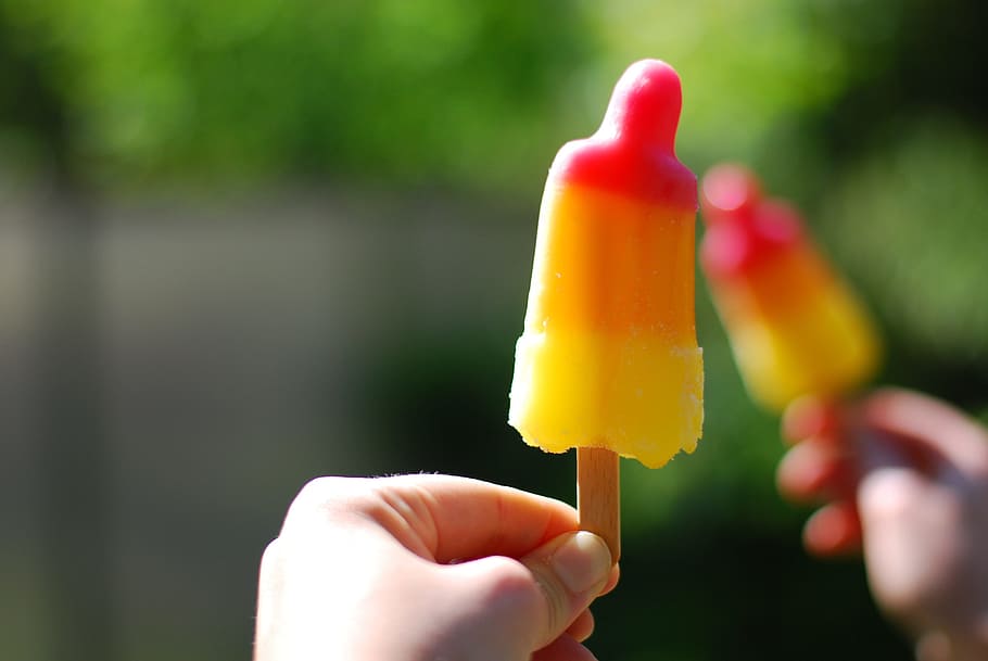 person holding popsicle, Ice Lolly, Play, Rocket, human hand, human body part, human finger, food and drink, outdoors, flavored ice