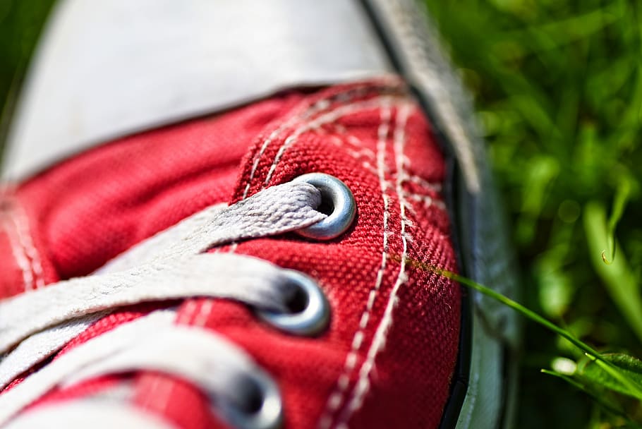 close-up photo, red, sneaker, foot, shoe, shoe laces, laces, eyelet, stitching, structure