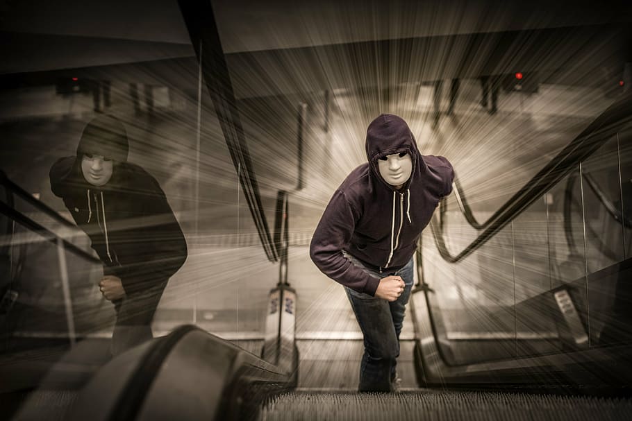 man, white, mask, hooded jacket, standing, escalator, run, city, urban, on the run