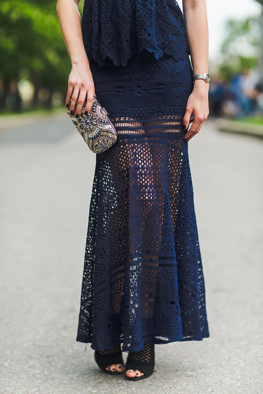 woman, wearing, blue, lace dress, black, peep-toe sandal, standing, asphalt road, daytime, women's