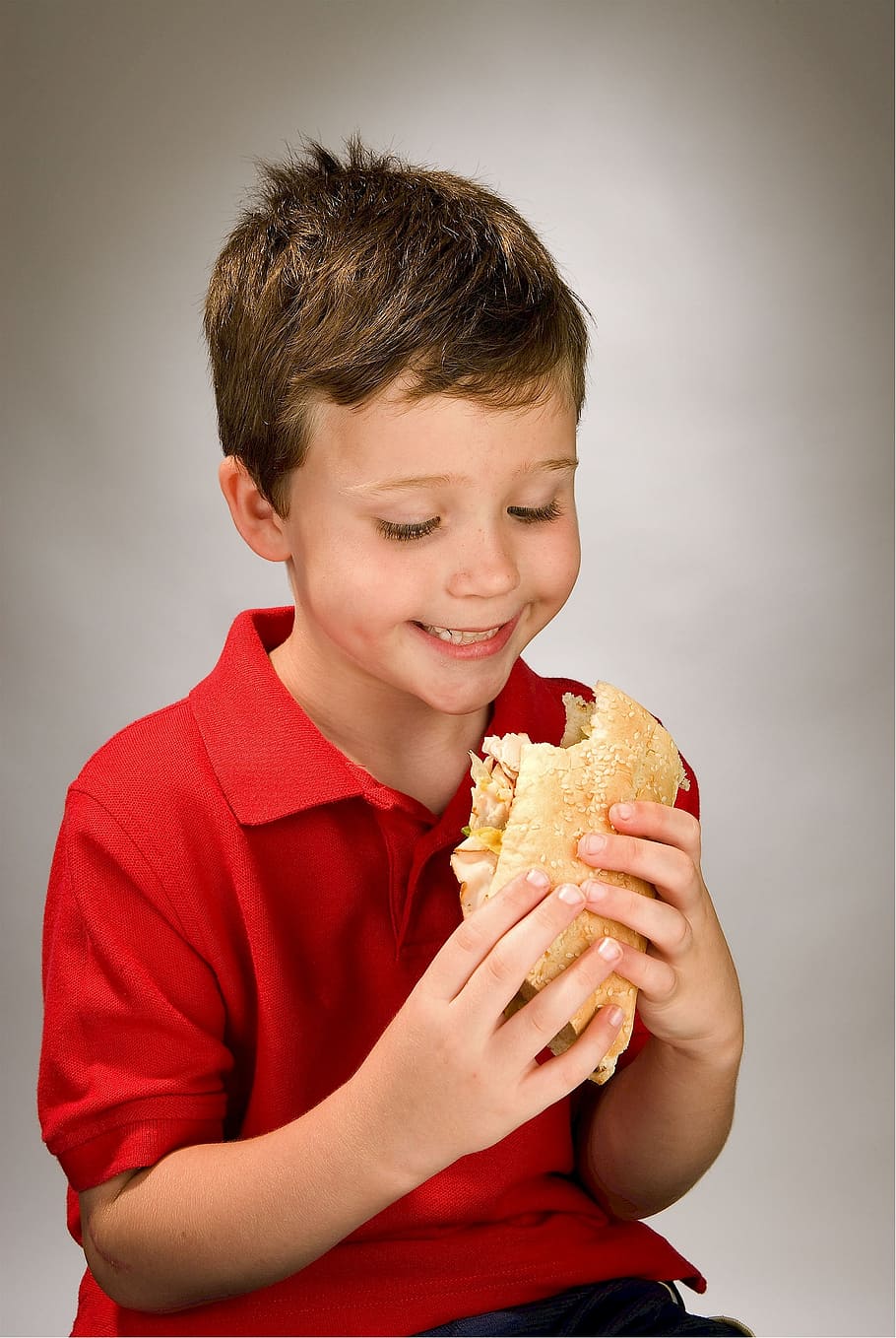 boy, holding, sandwich, child, eating, hoagie, grinder, blimpie, po' boy, meat