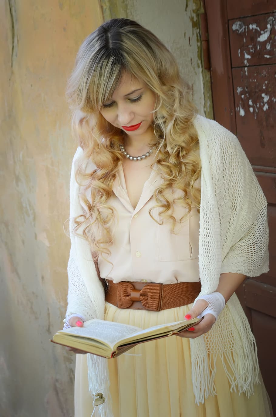 woman, wearing, white, knitted, headscarf, beige, bow-accent dress, holding, book, lovely