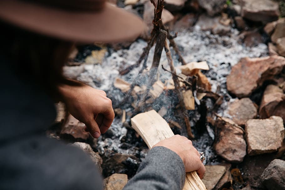 the stake, camping, camp, fire, stones, solid, one person, nature, hand, rock