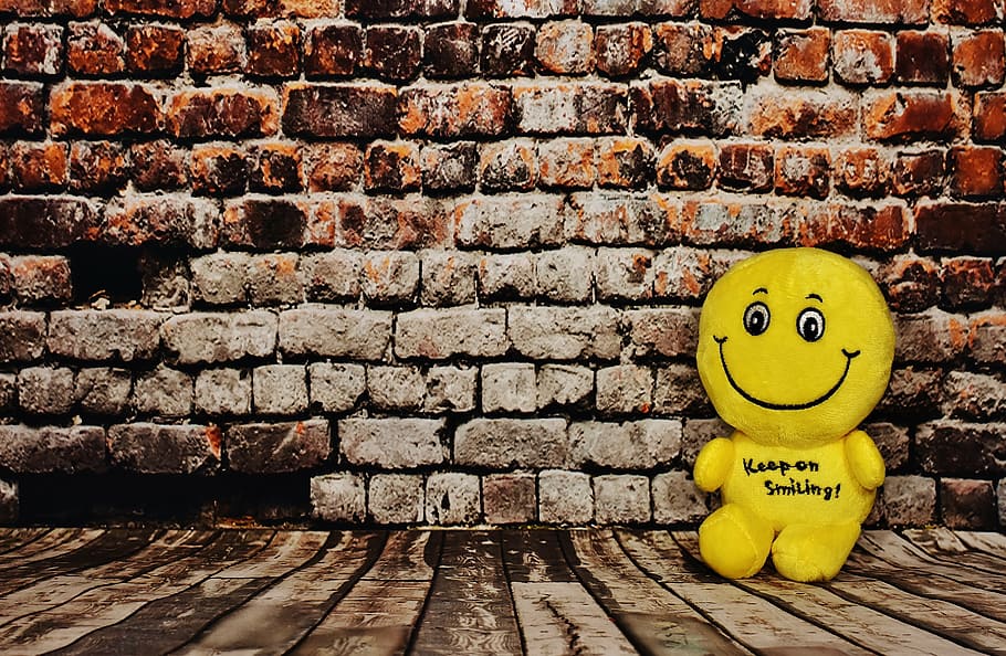 yellow, plush, toy, leaning, wall, laugh, smile, smiley, funny, emotion