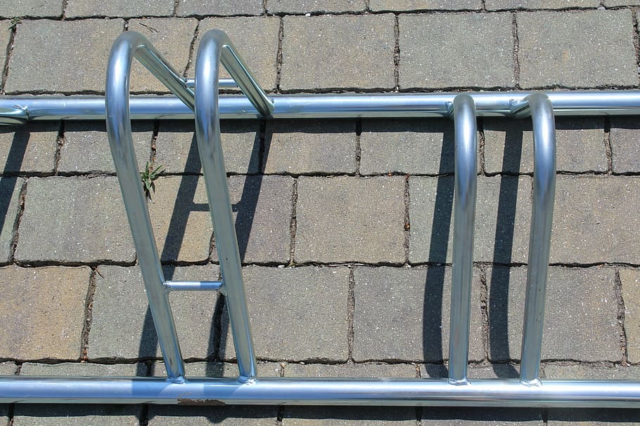 bicycle parking facility, bicycle accessories, bike, parking, metal, railing, day, high angle view, outdoors, architecture