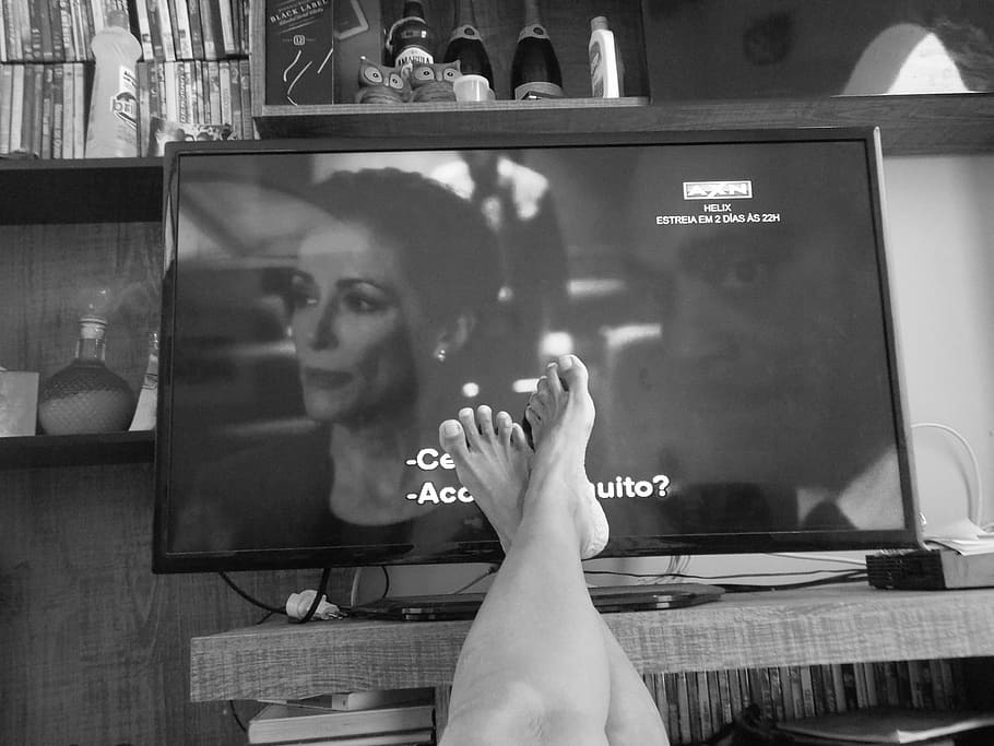 grayscale photo, person, feet, front, flat, screen tv, everyday, routine, tv, watching tv