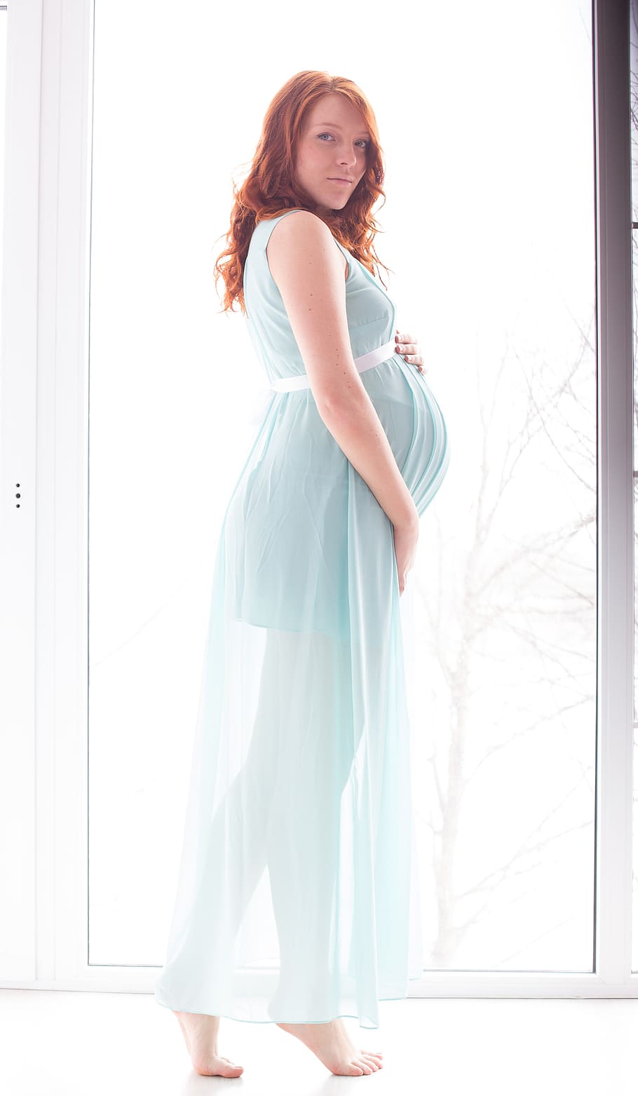 woman, wearing, green, sleeveless dress, pregnancy, mom, model, family, belly, expectant mother