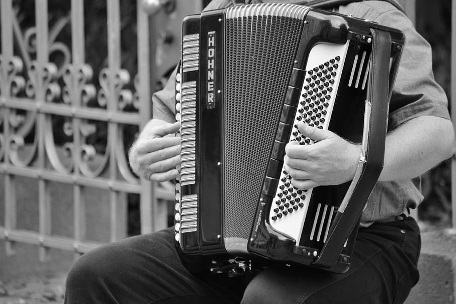greyscale photo, person, playing, button accordion, accordion, musical instrument, keyboard instrument, keyboard, musician, keys