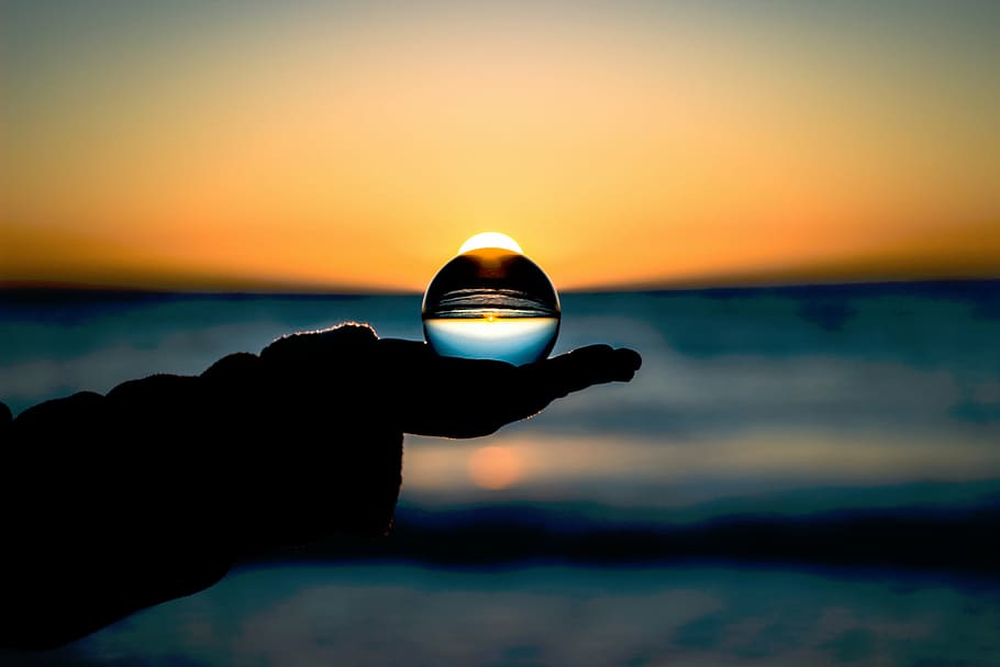 shallow, focus photography, silhouette, person, holding, crystal ball, nature, water, glass, sphere