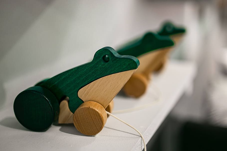 wooden, figure, strings, toy, frog, Small, frogs, indoors, focus on foreground, close-up