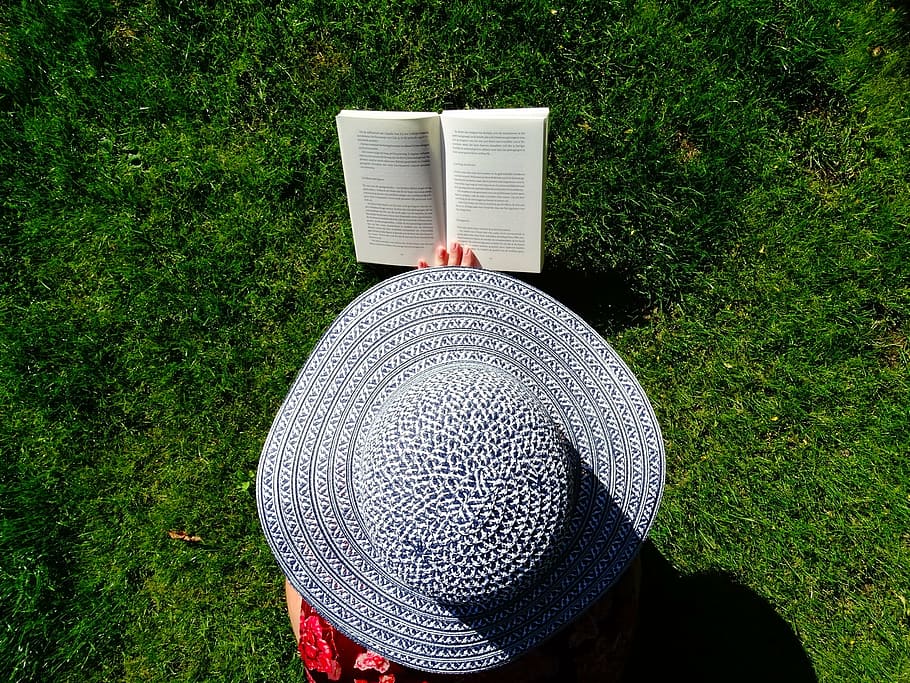 photograph, person, wearing, sun hat reading book, field, grass, hat, garden, read, summer