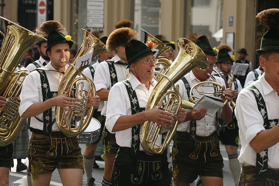 person, playing, wind instrument, oktoberfest, costume parade, blowers, musical instrument, group of people, music, brass instrument