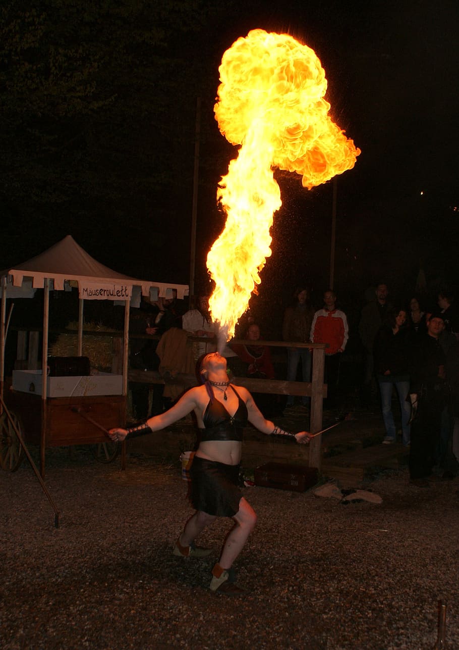 fire eaters, medieval market, a fire-eater, fire, spit fire, artist, full length, warning sign, real people, flame