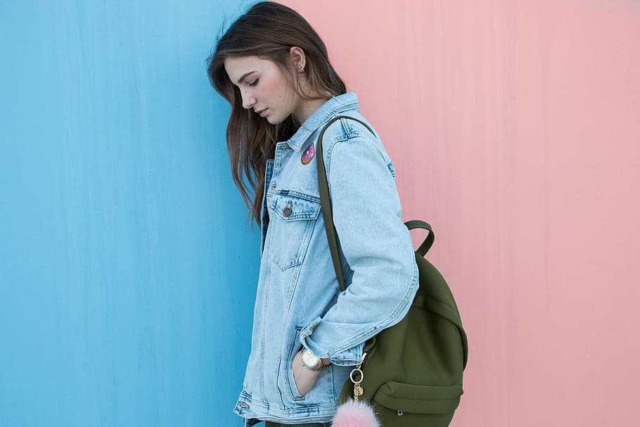 woman, wearing, green, backpack, wall, blue, denim, jacket, clothing, fashion