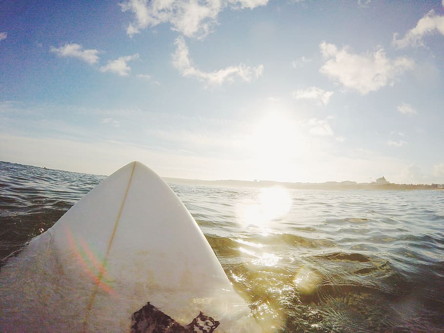 surfboard, surfing, ocean, sea, water, sunshine, sun rays, sports, sky, clouds