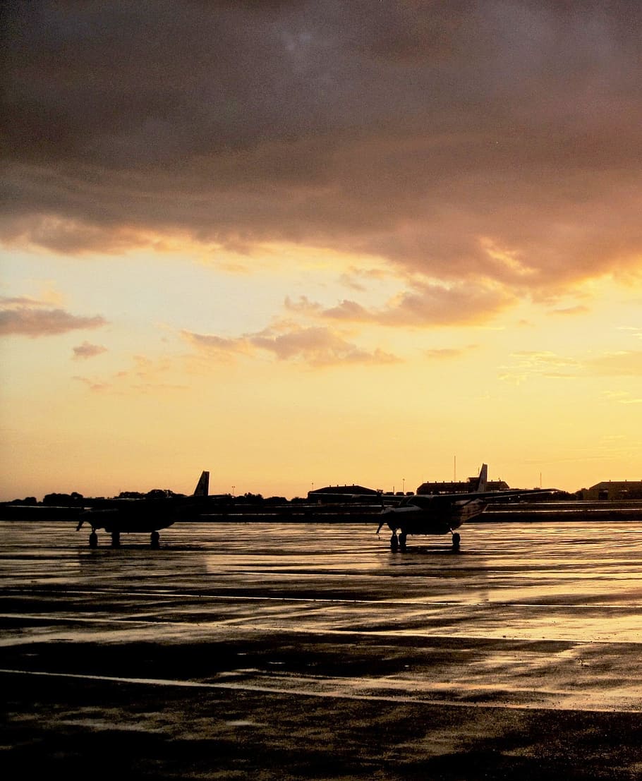 air field, air craft, tarmac, wet, rain, sunset, clouds, orange, gold, reflection