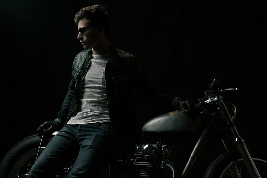 man, leaning, cafe racer, wearing, black, leather, zip, jacket, jeans, gray