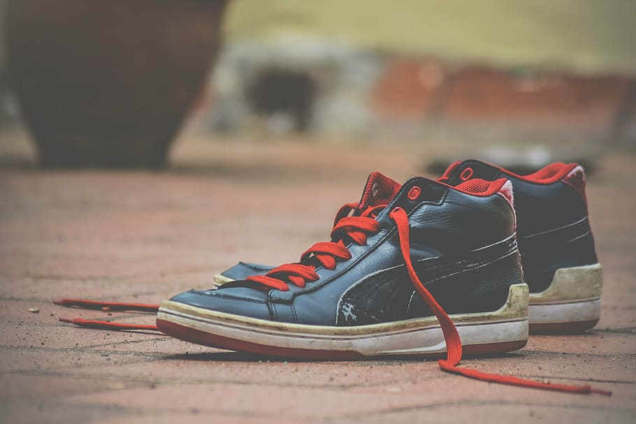 pair, black-and-red puma high-top sneakers, shoes, shoelaces, red, black, deck shoes, footwear, focus on foreground, sport