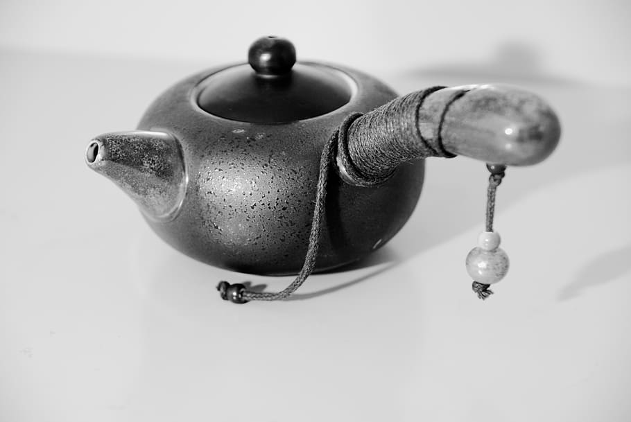 japanese clay teapot, tableware, black and white photo, close-up, teapot, indoors, metal, still life, hanging, focus on foreground