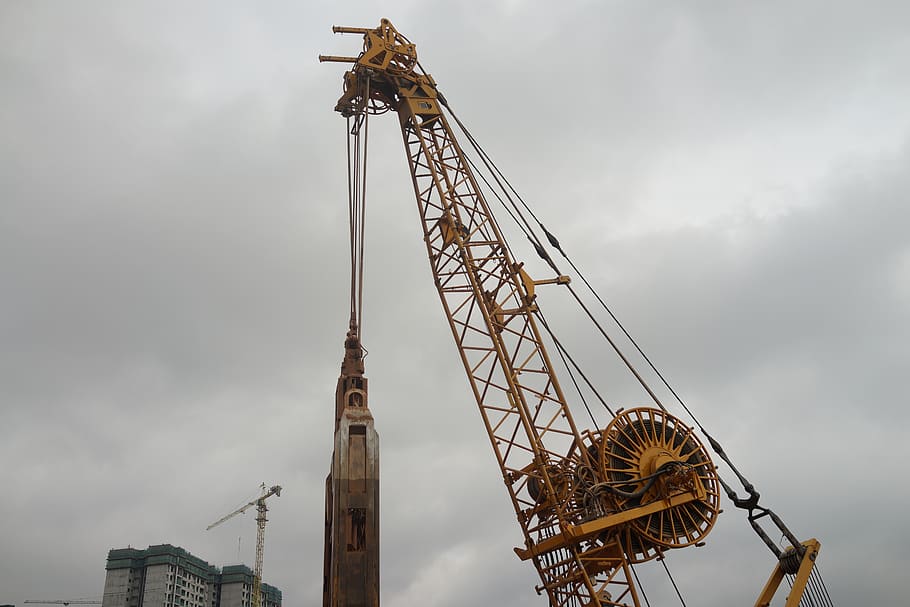 asian construction site, heavy machinery, super lifting power, foundation work, building frenzy, hoisting, yellow crane, sky, machinery, low angle view