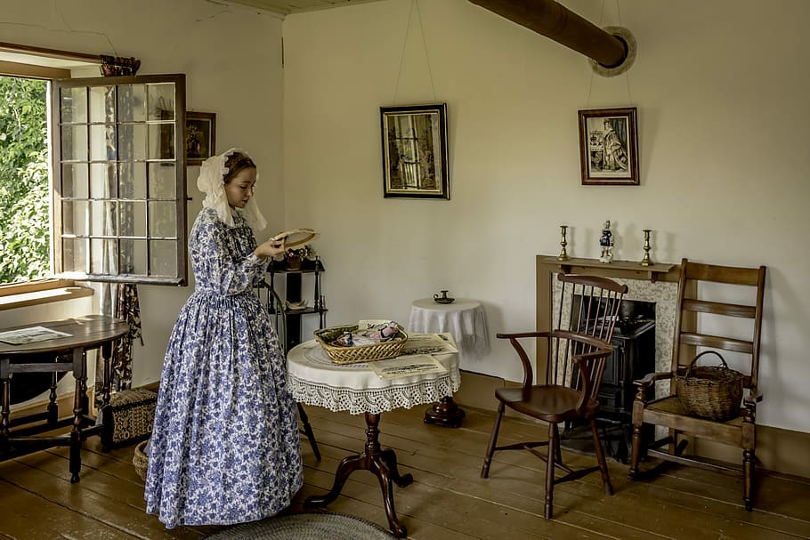 woman, standing, front, pedestal table, furniture, room, chair, indoors, pioneer, needlework