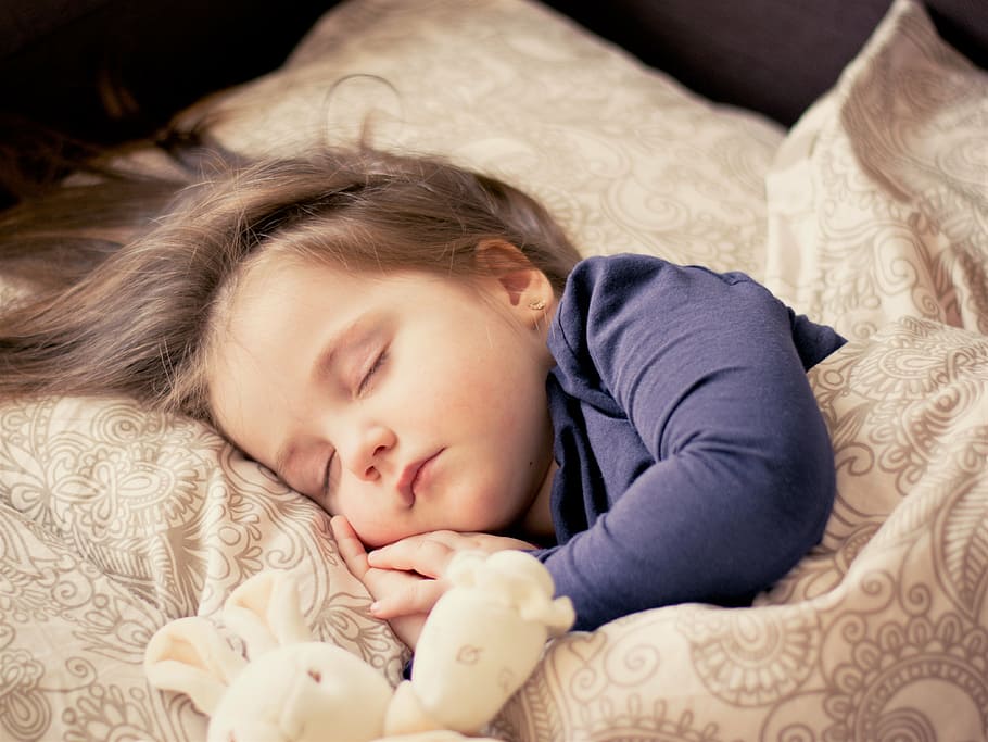 toddler, wearing, black, long-sleeved, shirt, sleeping, brown, bed comforter, set, baby