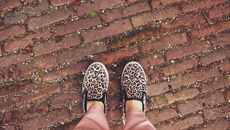 cheetah print, shoes, cobblestone, ground, low section, shoe, one person, human body part, body part, human leg