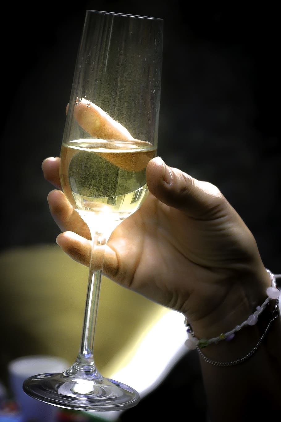 person, holding, clear, flute champagne glass, filled, yellow, liquid, Vine, Wine, Celebration