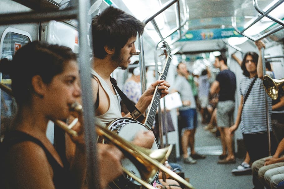 band, performing, inside, train, passengers, people, instrument, guitar, string, fret