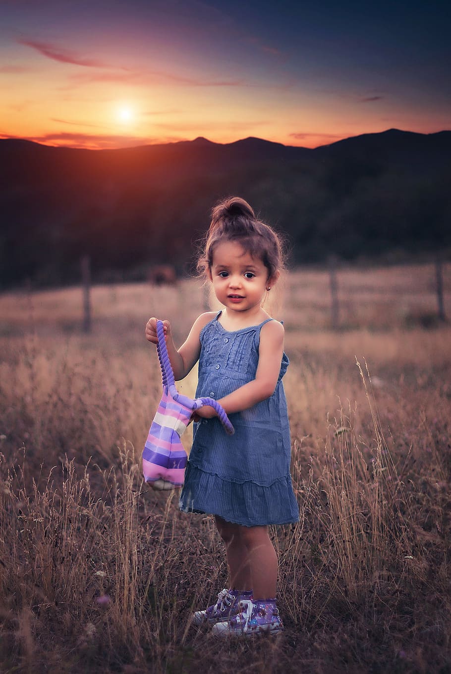 girl, wearing, blue, chambray spaghetti, strap, dress, holding, purple, striped, bag