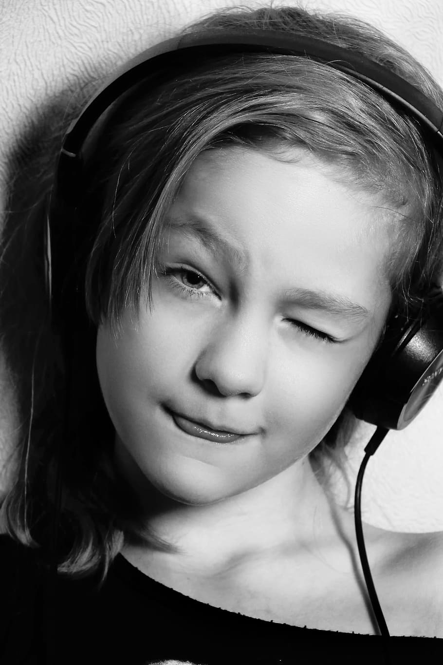 grayscale photo, girl wink, left, eye, wearing, headpohnes, headsets, music, to listen, model