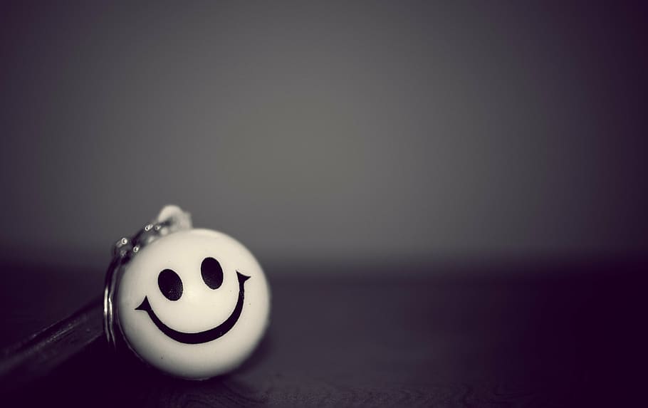 white emoticon keychain, smiley, clown, key chain, black, indoors, smiling, copy space, representation, close-up