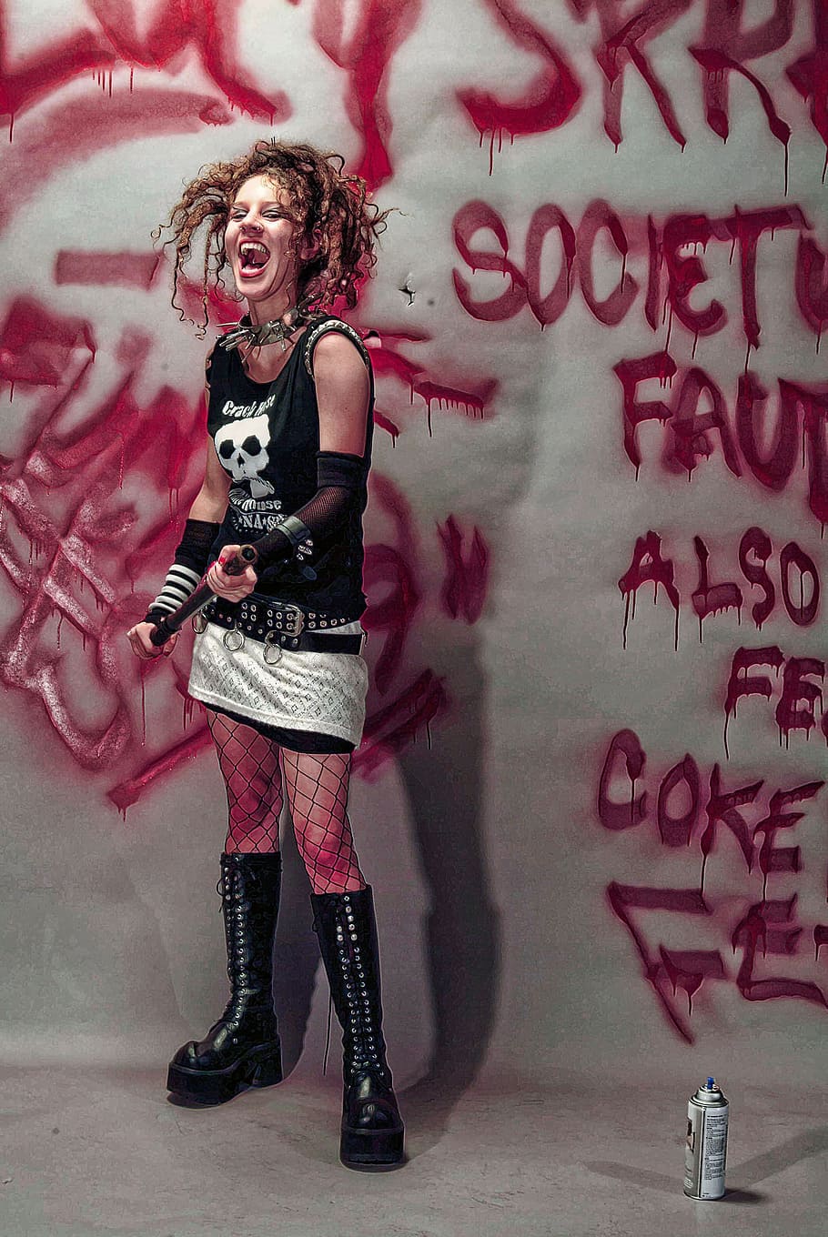 woman, standing, holding, bat, laughing, graffiti, spray paint, young, dreadlocks, fun