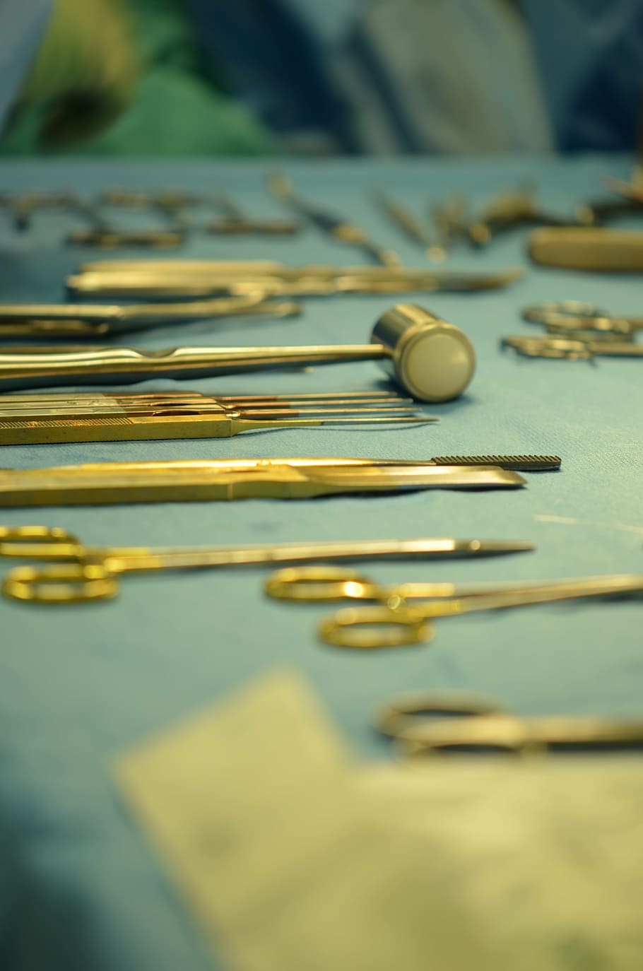 gold-colored scissor lot, table, doctor, surgeon, operation, instruments, medical, health, selective focus, close-up