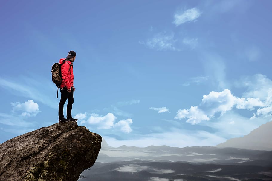 man, wears, red, jacket, standing, rock formation, daytime, mountain, hiking, adventure