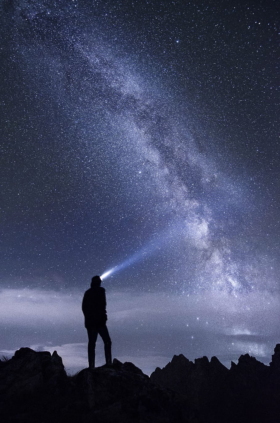 man, standing, rock, night time, silhouette, person, headlights, looking, stars, night