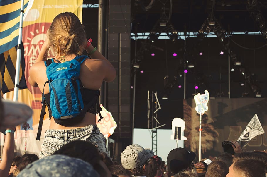 woman, wearing, blue, backpack, facing, stage, concert, light, music, band
