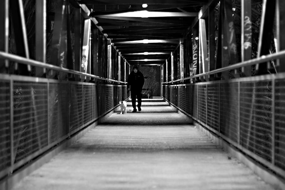 grayscale photo, man, walking, hallway, white, black, passage, soledad, drama, feeling
